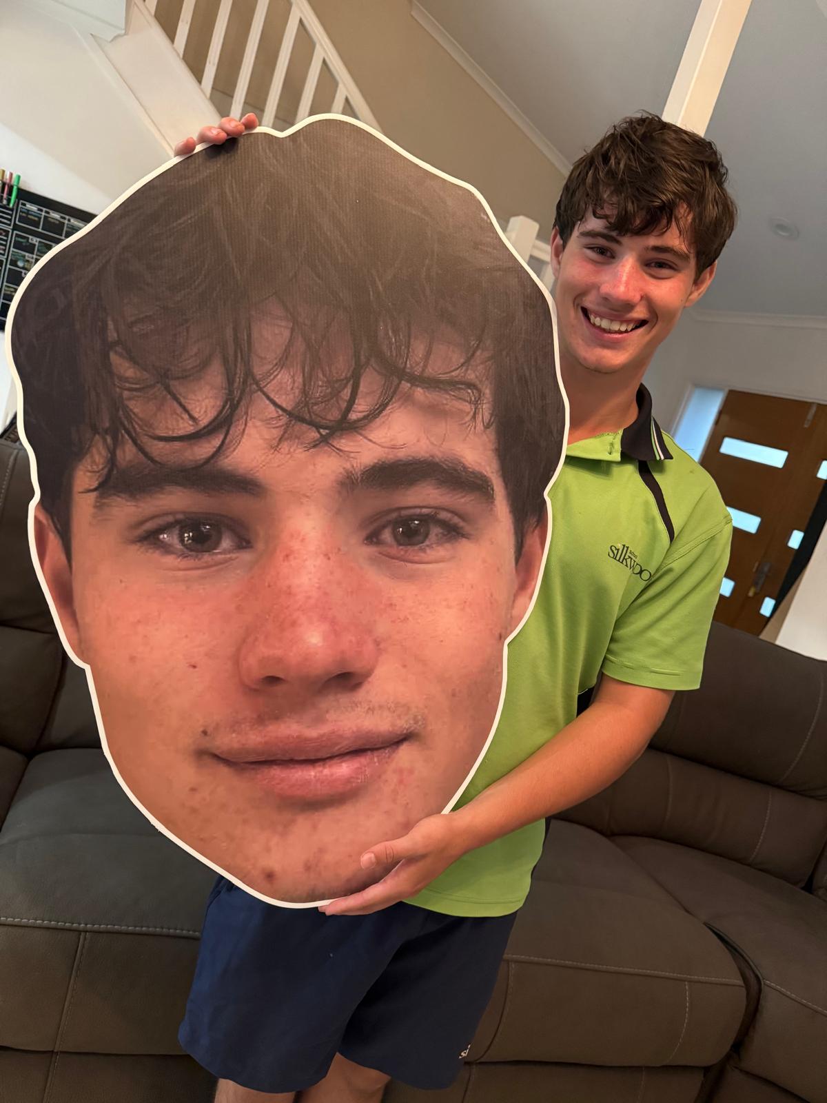 Player holding his Big Head cut-out